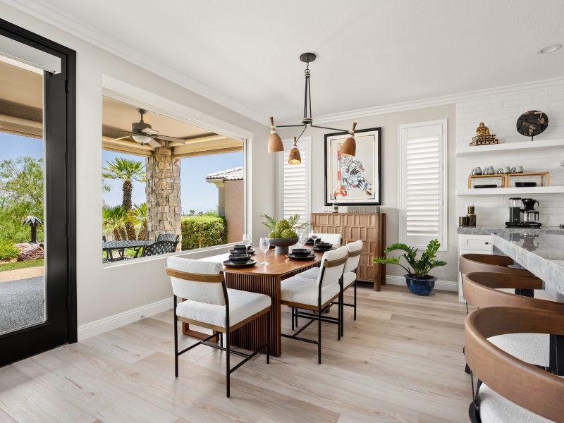 Japandi-inspired dining room with walnut table, cloud-fabric seating, and sculptural wood-and-metal chandelier, Reveal Interior Design Las Vegas