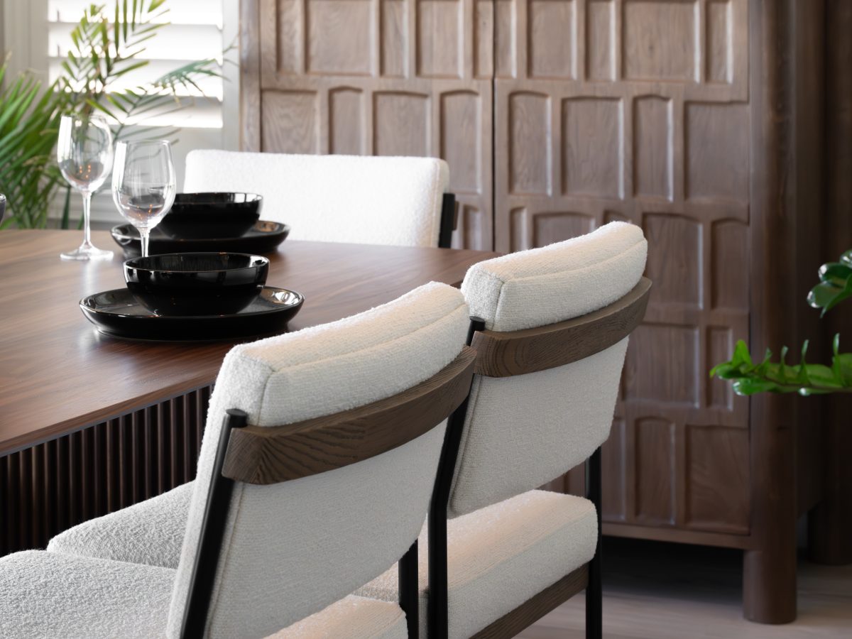 Japandi dining room with walnut table, dimensional storage cabinet, and cloud-fabric seating, Reveal Interior Design Las Vegas
