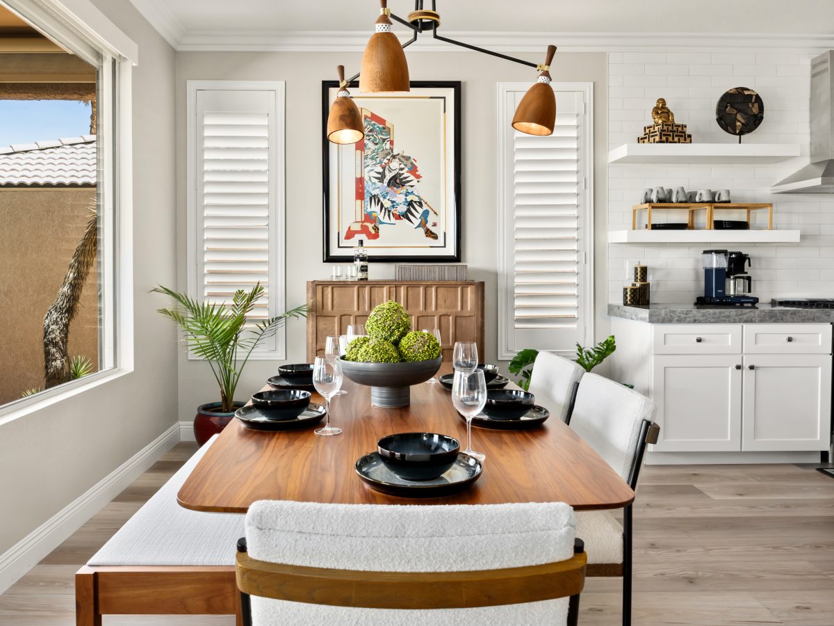 Japandi-inspired dining room with modern walnut table, sculptural chandelier, and cloud fabric seating, Reveal Interior Design Las Vegas