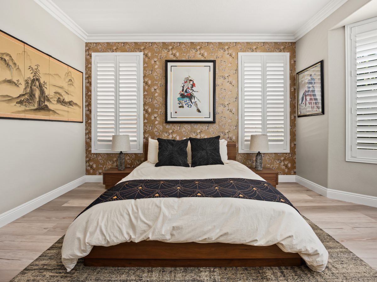 Primary bedroom with gold Japanese-inspired wallpaper and walnut bed frame, Reveal Interior Design Las Vegas