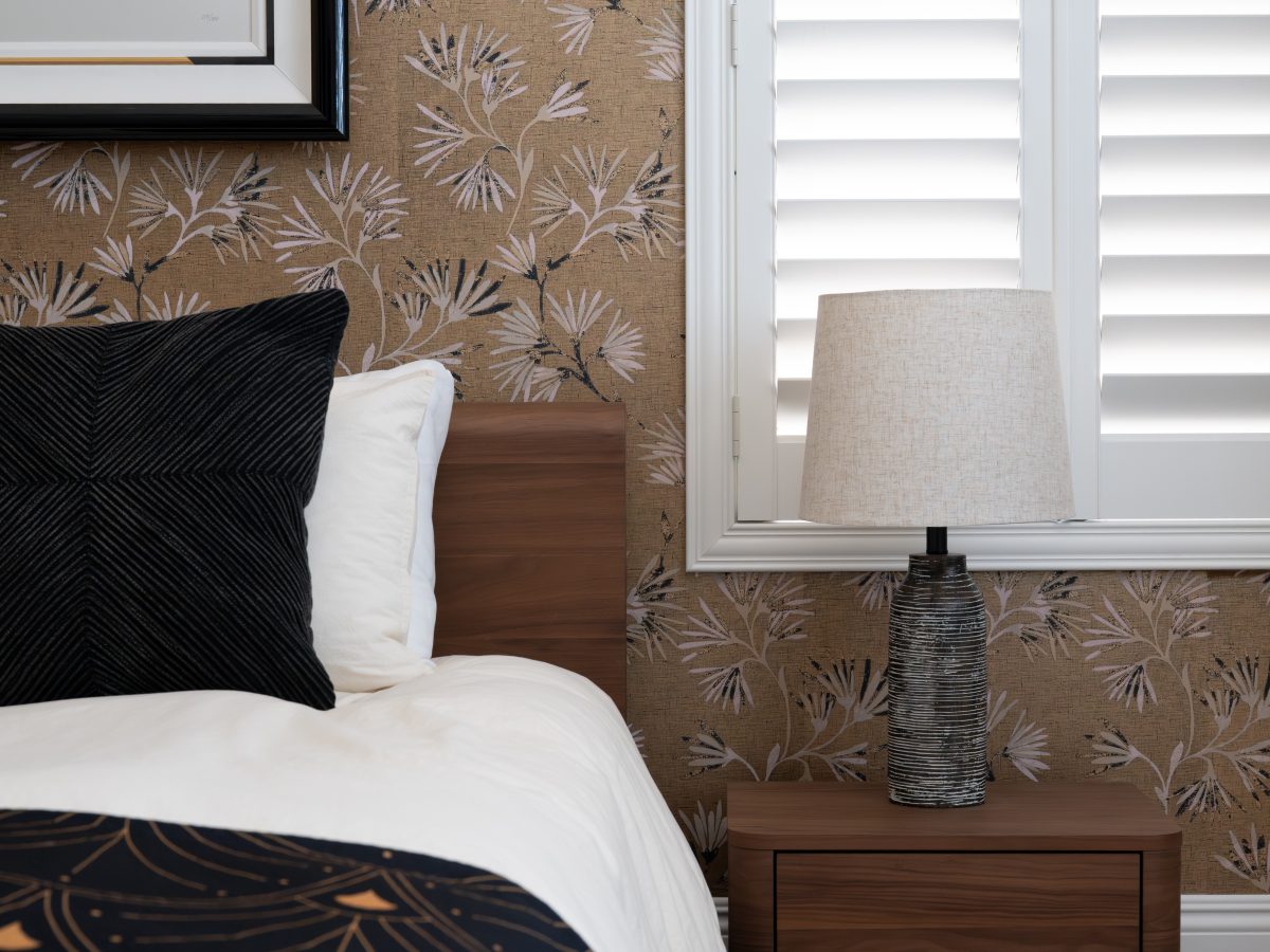 Primary bedroom with gold metallic Japanese-inspired wallpaper and walnut bed and nightstands, Reveal Interior Design Las Vegas
