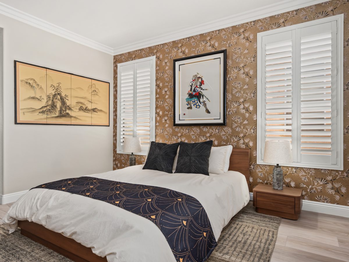 Primary bedroom with gold metallic Japanese-inspired wallpaper and low walnut bed, Reveal Interior Design Las Vegas