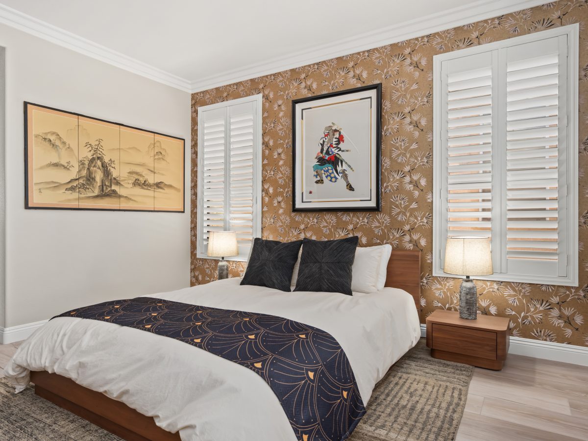 Primary bedroom with gold metallic Japanese-inspired wallpaper and low walnut bed, Reveal Interior Design Las Vegas