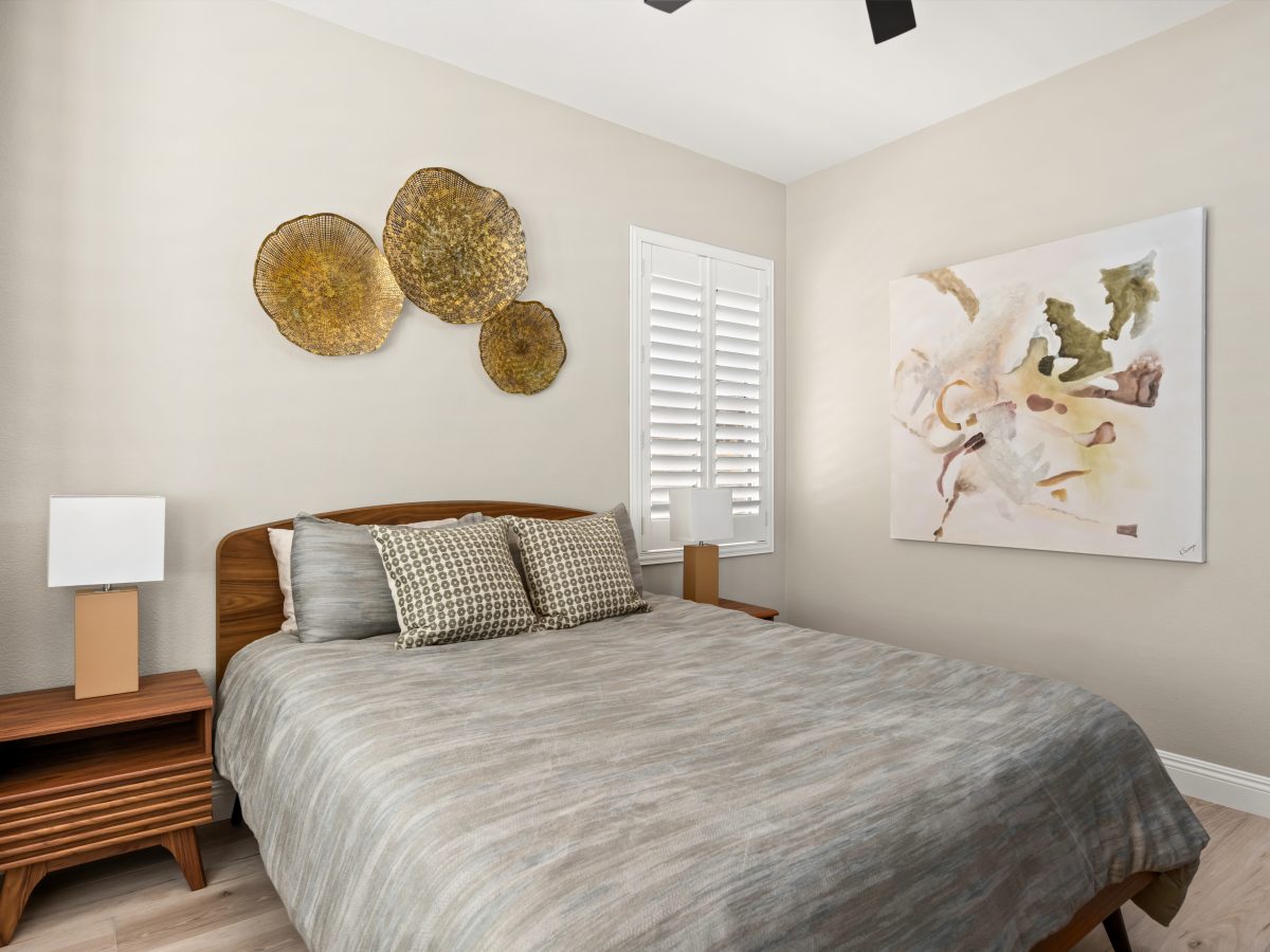 Modern bedroom with walnut headboard, dimensional metal wall art, and contemporary canvas, Reveal Interior Design Las Vegas