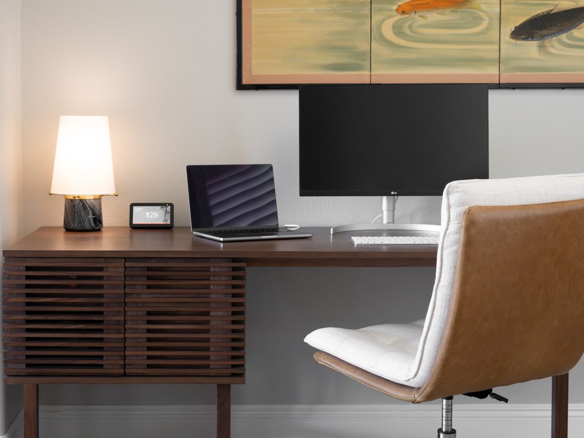 Modern home office with Japanese-inspired wall art, walnut storage desk, and fabric desk chair, Reveal Interior Design Las Vegas