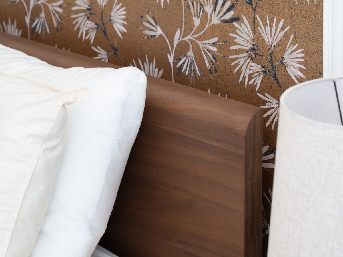 Primary bedroom with gold metallic Japanese-inspired wallpaper and low walnut platform bed, Reveal Interior Design Las Vegas