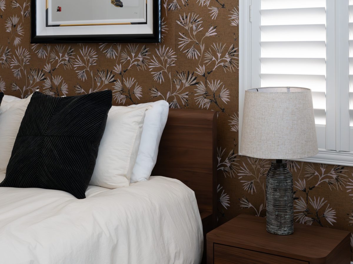 Primary bedroom with gold metallic Japanese-inspired wallpaper and low walnut bed, Reveal Interior Design Las Vegas