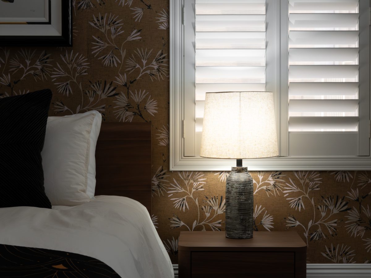 Primary bedroom with gold metallic Japanese-inspired wallpaper, walnut bed and nightstands, white shutters, Reveal Interior Design Las Vegas