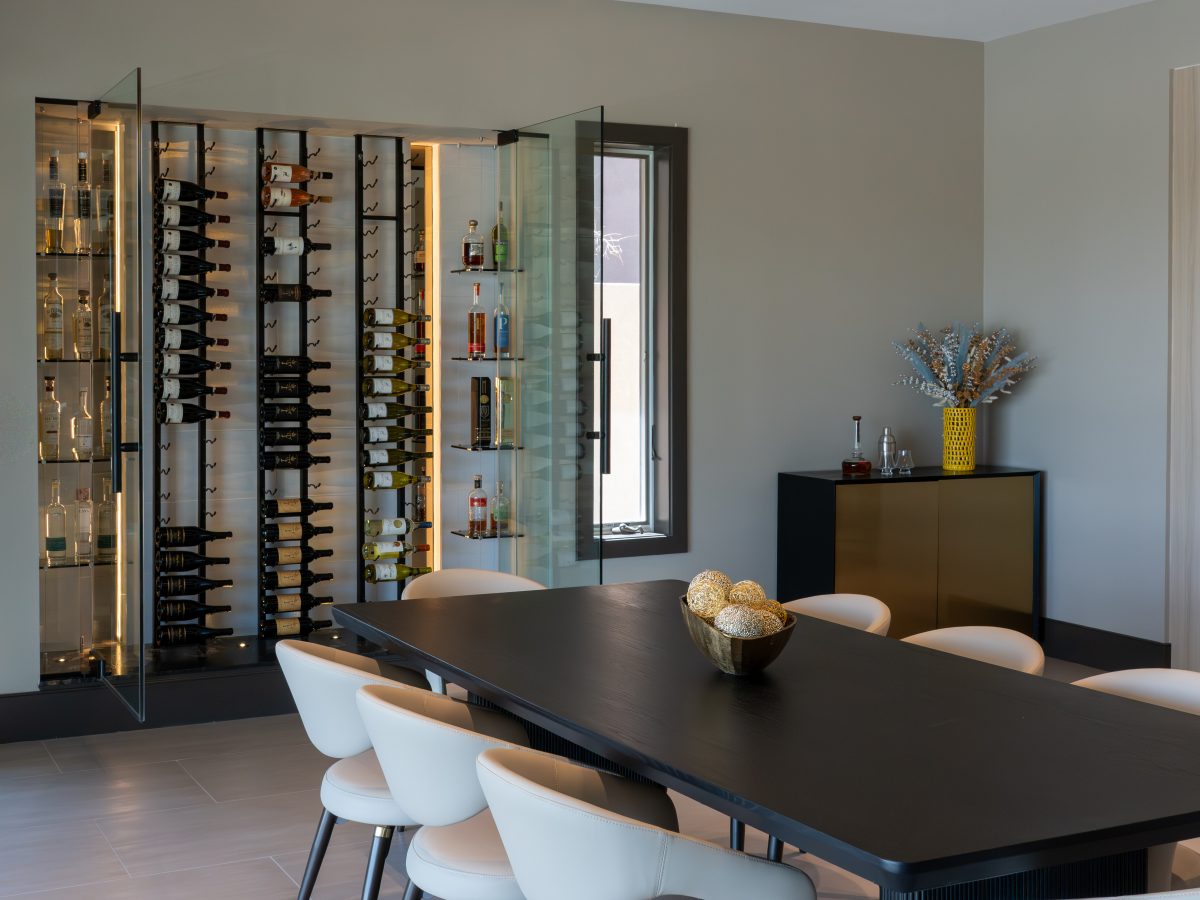 Custom wine niche with modern metal shelving, mirrored panels, and hidden LED lighting, Reveal Interior Design Las Vegas
