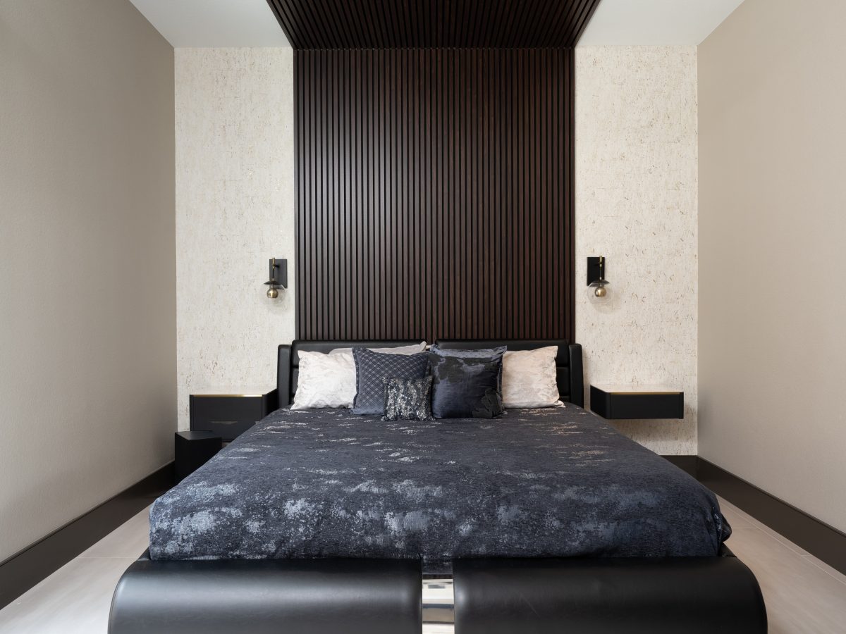 Guest bedroom with dramatic floor-to-ceiling wood panel headboard and cork-look wallcovering, Reveal Interior Design Las Vegas