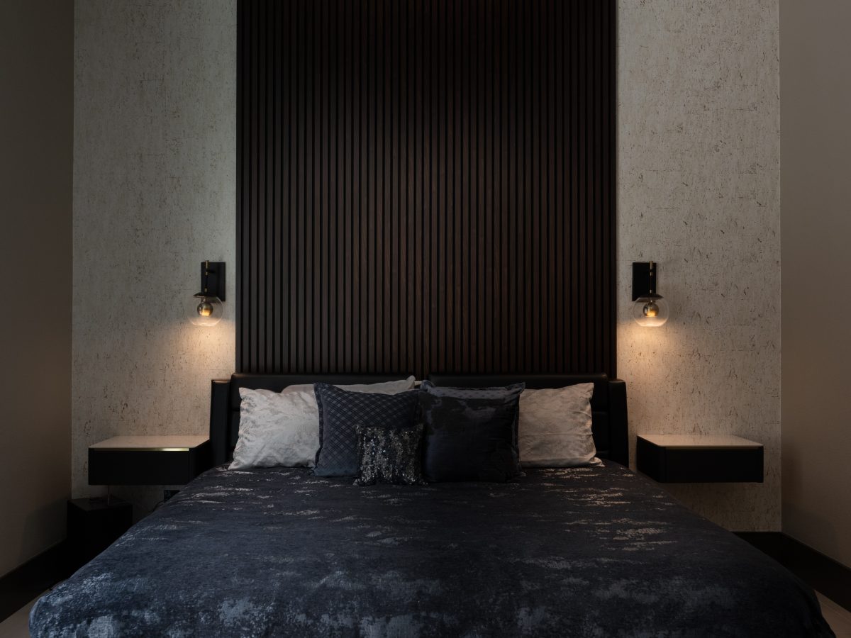Guest bedroom with dramatic floor-to-ceiling wood panel headboard and cork-look wallpaper, Reveal Interior Design Las Vegas