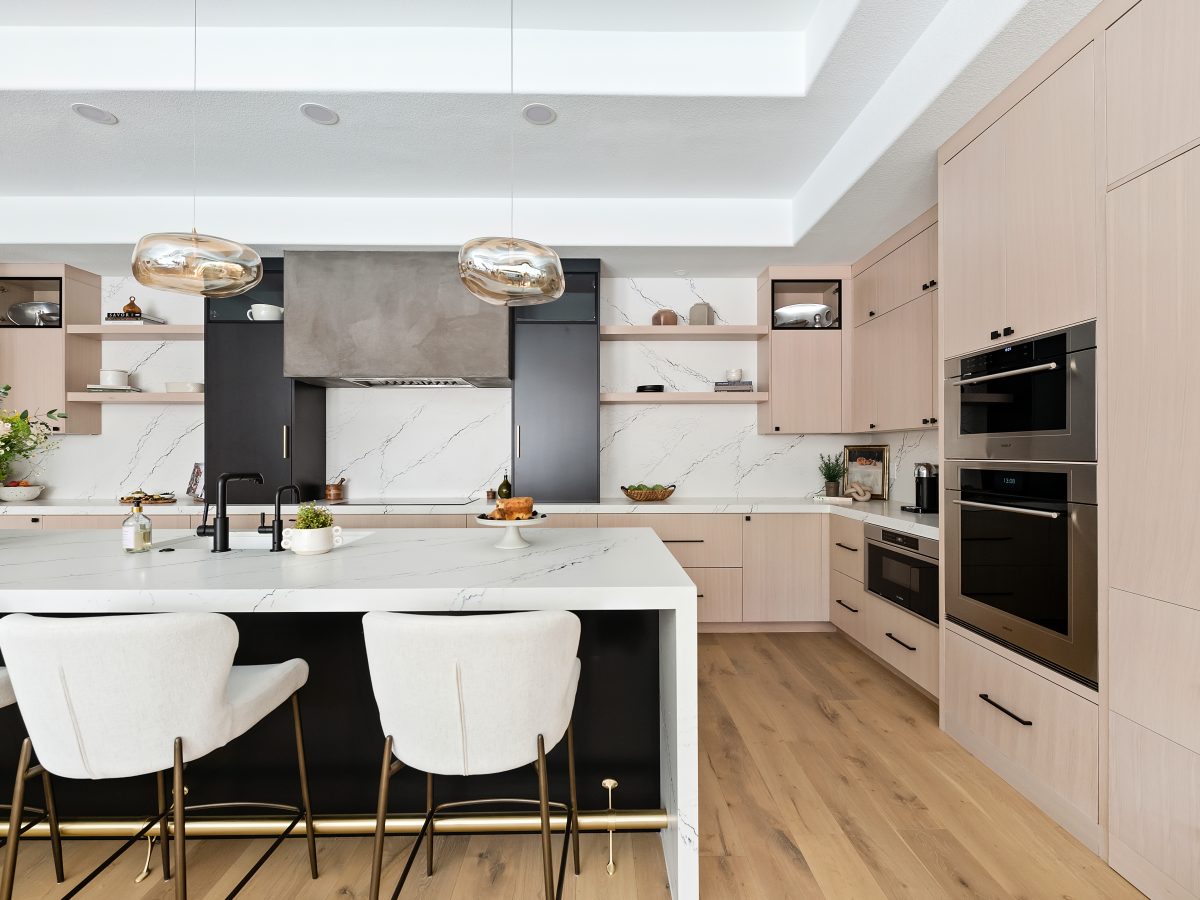 Luxury kitchen with whitewashed oak cabinetry, black quartz countertops, and matte black accents, Reveal Interior Design Las Vegas