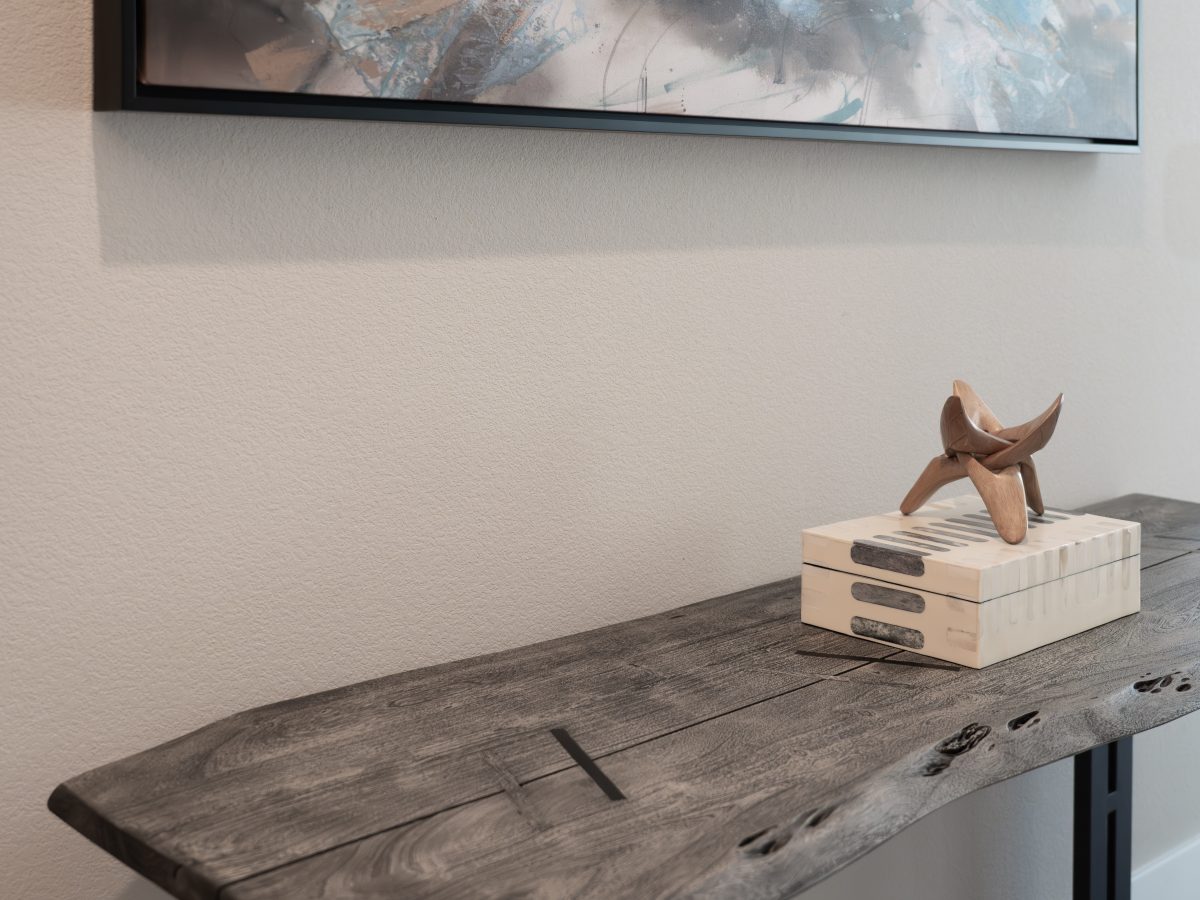 Entryway with live-edge console table, contemporary tropical artwork, and decorative accents, Reveal Interior Design Las Vegas