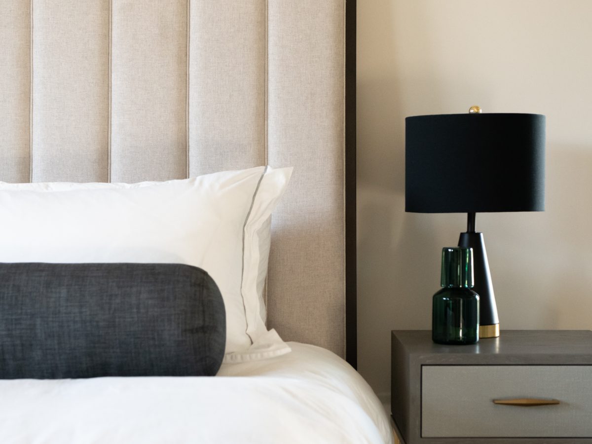 Casita king bedroom with channeled tufted upholstered headboard and walnut accents, Reveal Interior Design Las Vegas