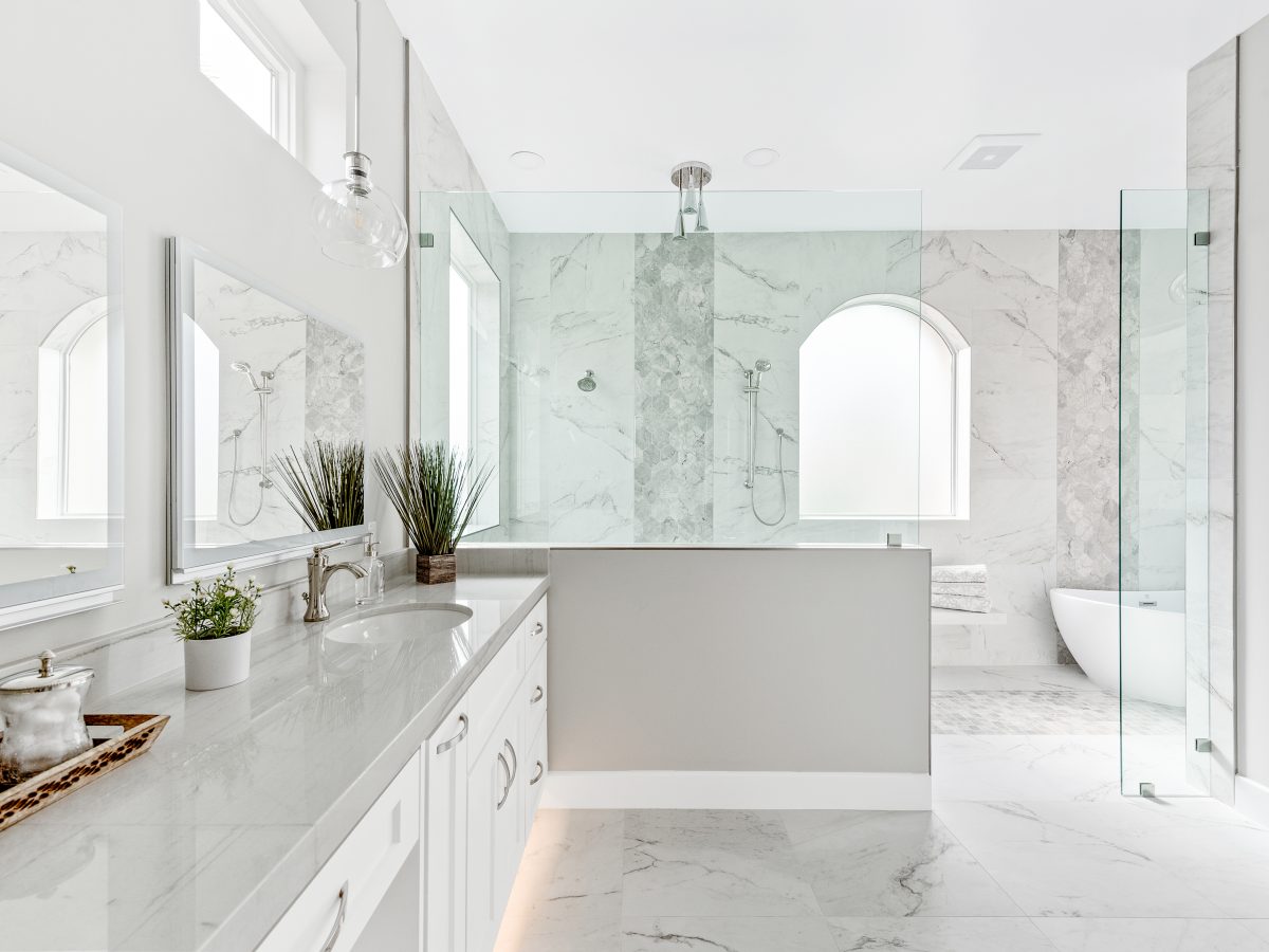 Transitional primary bathroom wet room with Taj Mahal quartzite vanity and marble-look porcelain tile, Reveal Interior Design Las Vegas