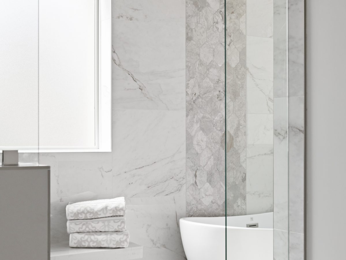Transitional primary bathroom wet room with marble-look porcelain tile and freestanding tub, Reveal Interior Design Las Vegas