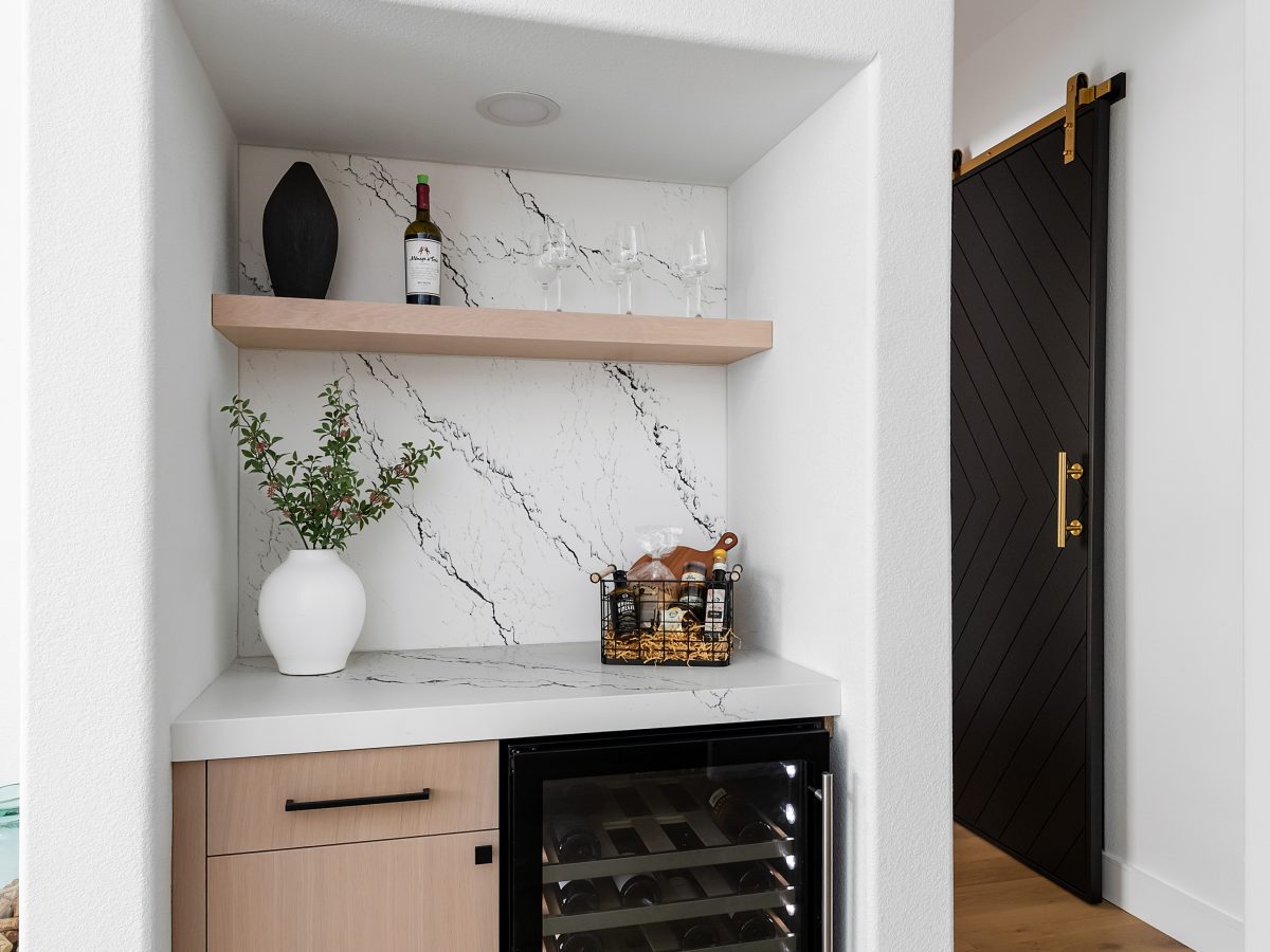 Built-in home bar with black-veined white quartz and whitewashed oak cabinetry, Reveal Interior Design Las Vegas