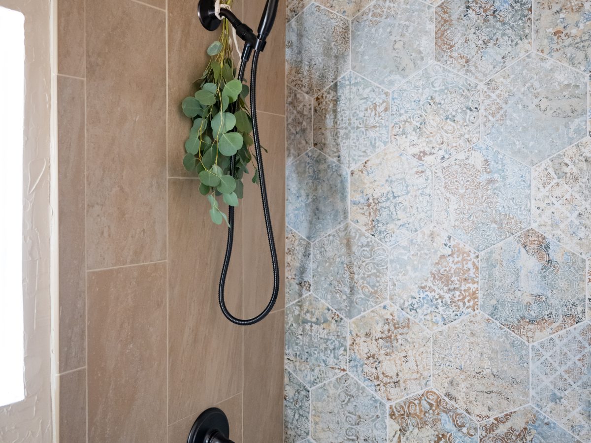 Modern Spanish-style guest bathroom with hex encaustic accent tile and oil-rubbed bronze fixtures, Reveal Interior Design Las Vegas