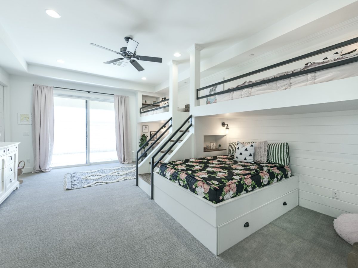 Custom queen-and-twin bunk bed suite with white millwork and black metal framing, Reveal Interior Design Las Vegas