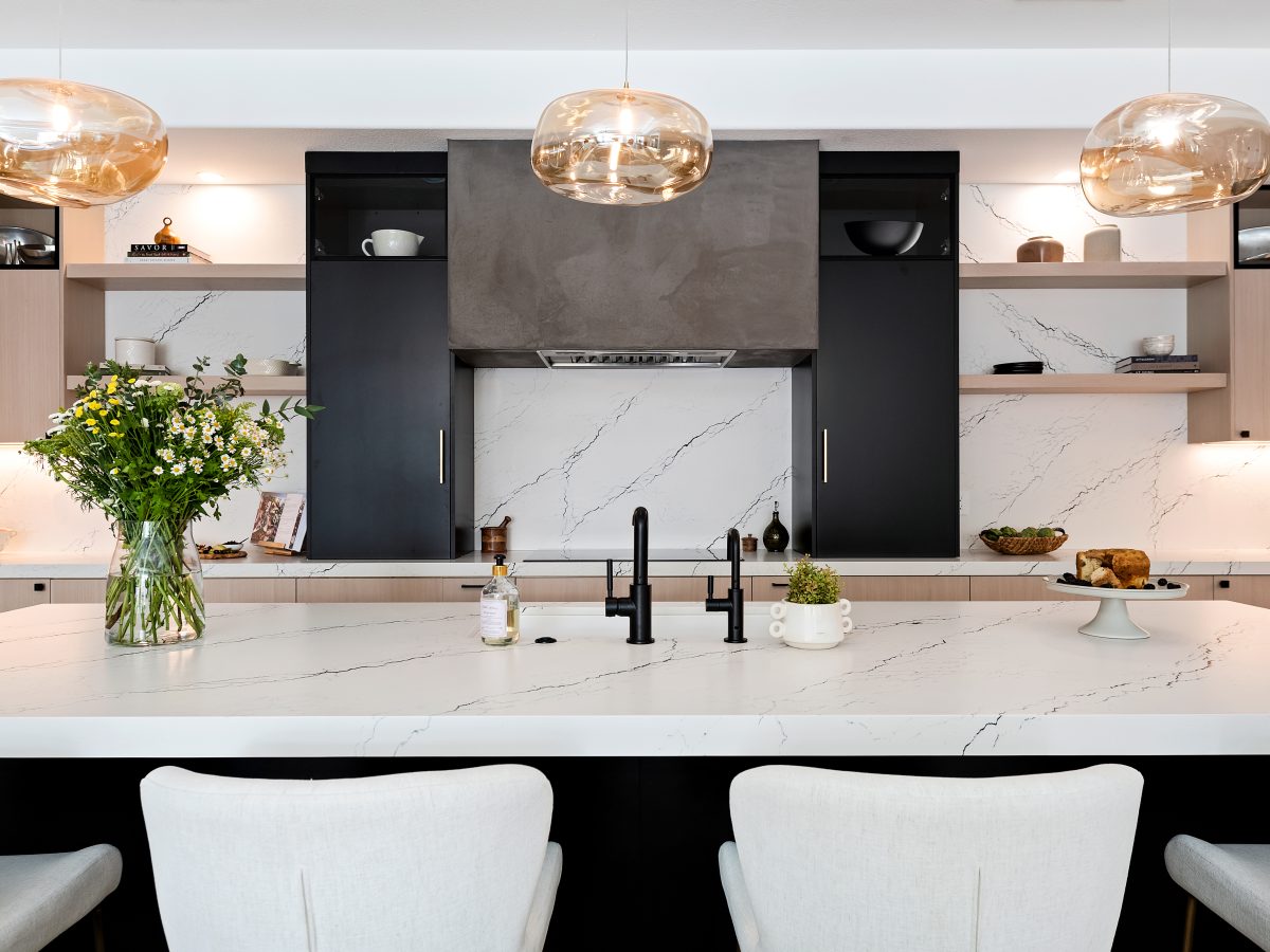 Contemporary kitchen with black-veined white quartz island, whitewashed oak cabinetry, and matte black accents, Reveal Interior Design Las Vegas