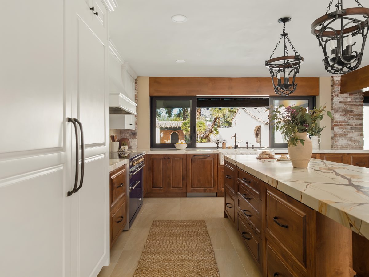 Spanish Modern kitchen with blue-gold quartzite island, maple cabinetry, and cream uppers, Reveal Interior Design Las Vegas