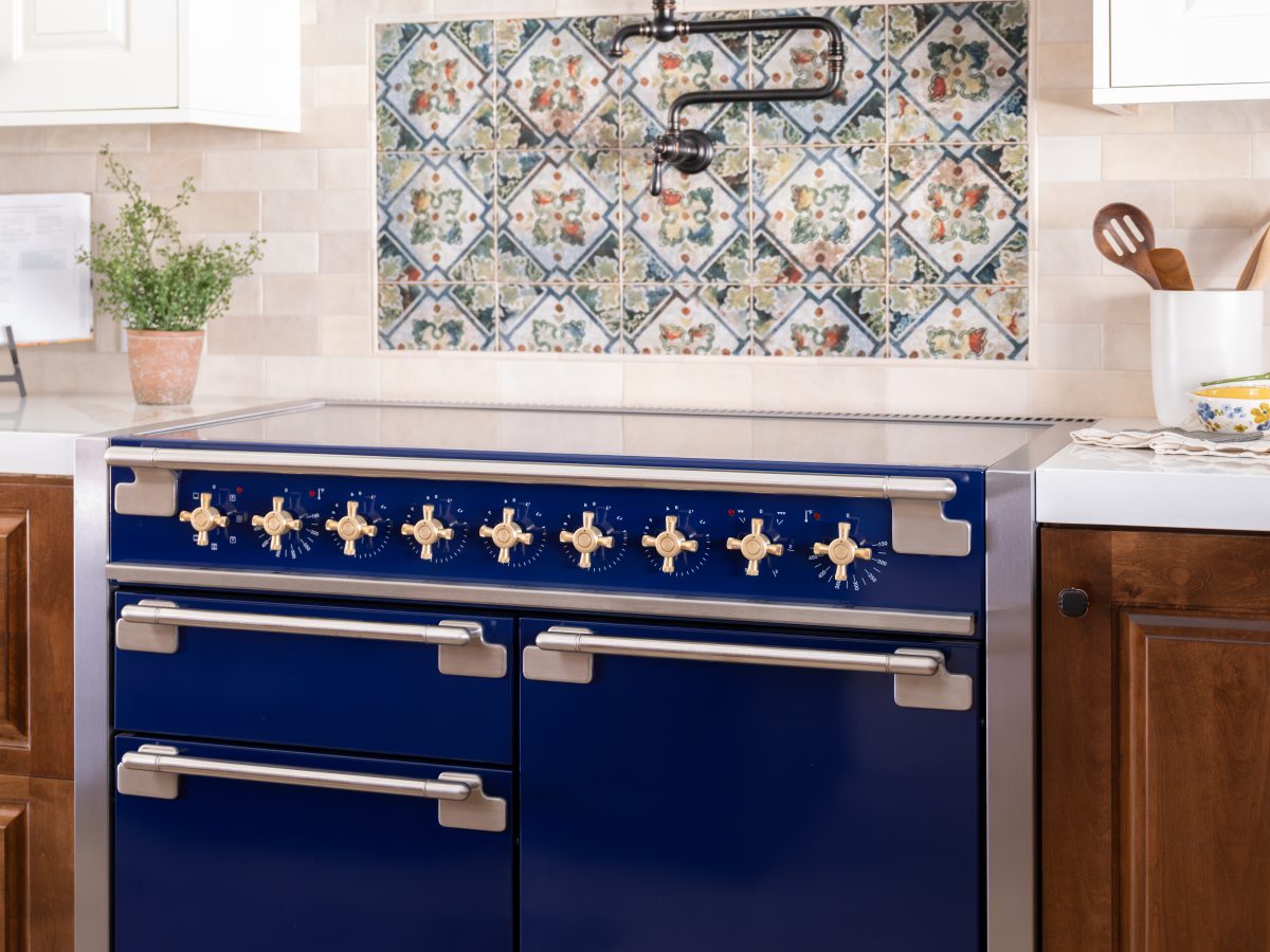 Spanish Modern kitchen with striking blue AGA dual-fuel range and encaustic tile backsplash, Reveal Interior Design Las Vegas
