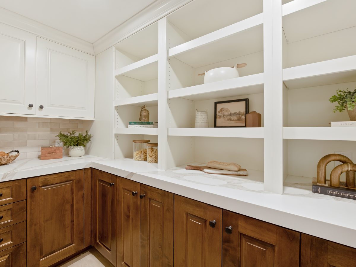 Transitional butler's pantry with maple stained lower cabinetry, cream open shelving, and quartz countertops, Reveal Interior Design Las Vegas