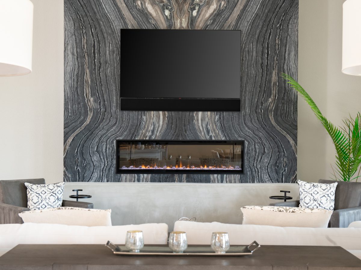 Living room with bookmatched leathered quartzite fireplace wall and linear electric fireplace, Reveal Interior Design Las Vegas
