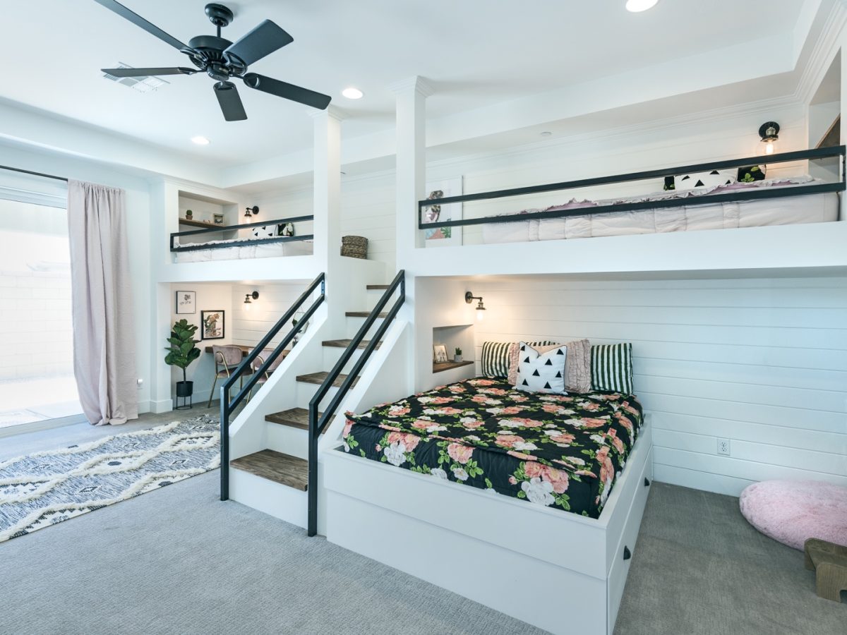 Custom queen-and-twin bunk bedroom with white millwork and black metal framing, Reveal Interior Design Las Vegas
