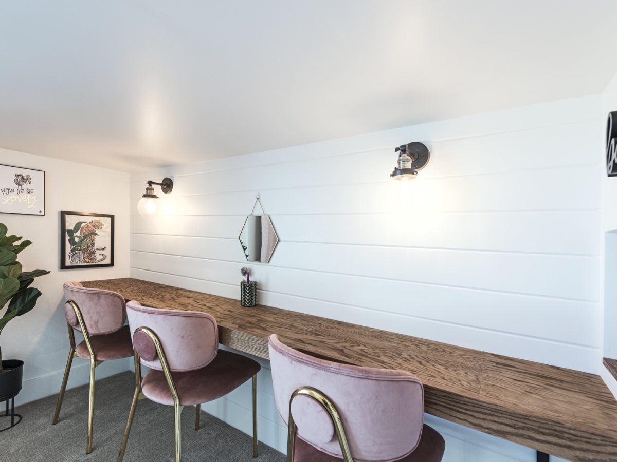 Three-girl bedroom vanity desk with pink velvet chairs and shiplap accent wall, Reveal Interior Design Las Vegas