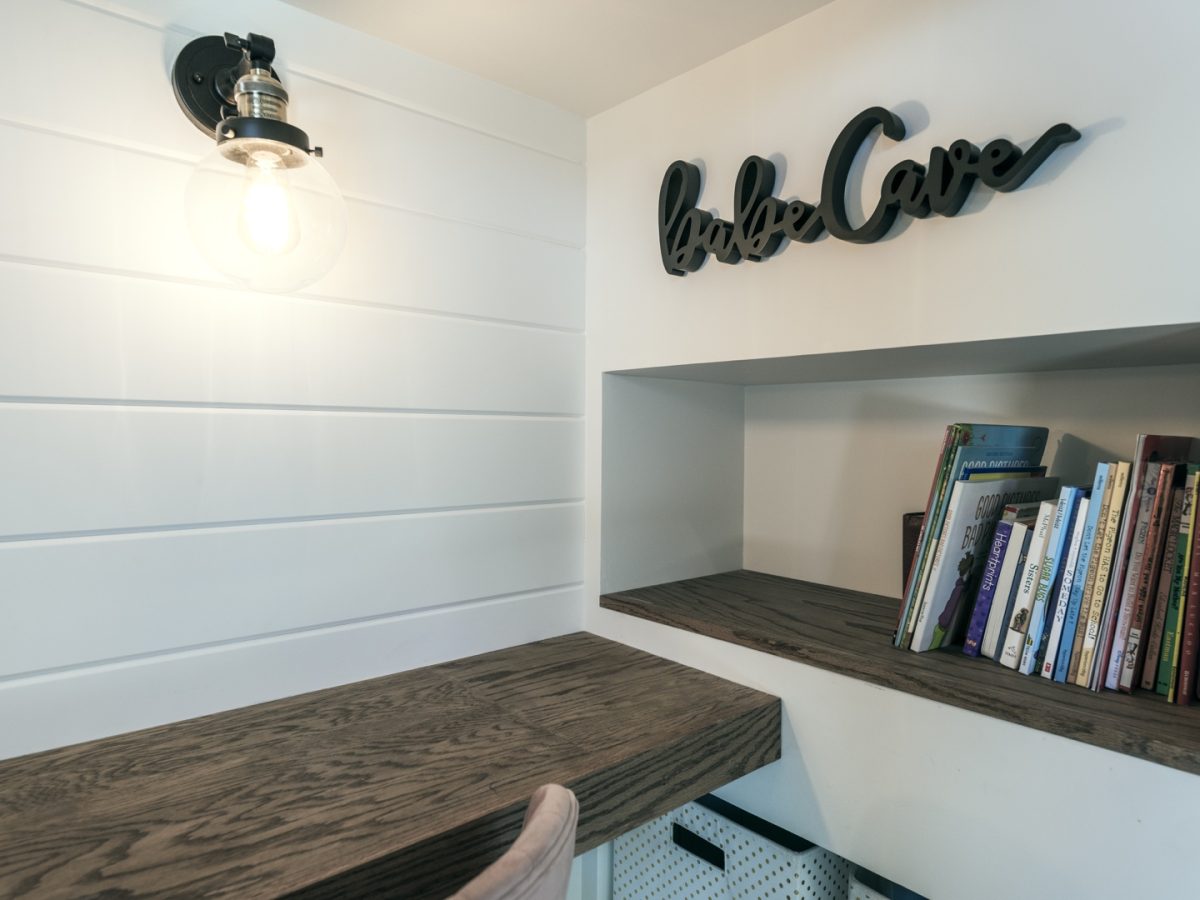 Girls' bedroom babe cave nook with built-in bookshelf, shiplap wall, and warm wood desk, Reveal Interior Design Las Vegas