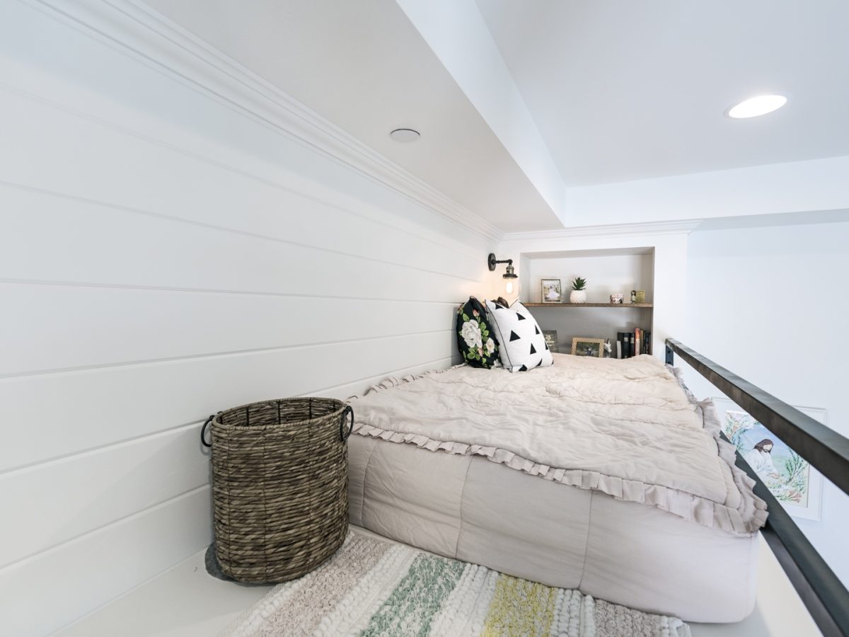 Girl's loft bunk bedroom with white shiplap, black metal framing, and built-in shelving, Reveal Interior Design Las Vegas