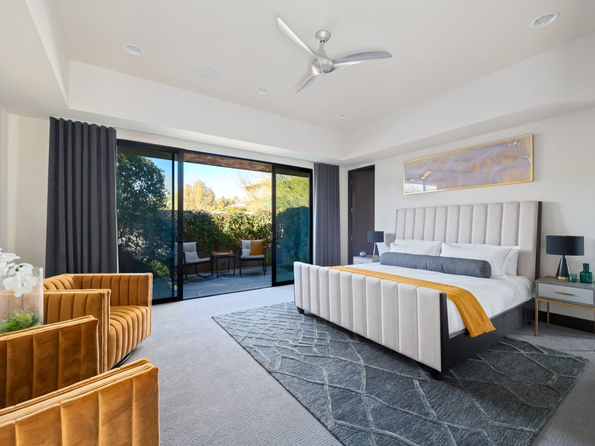 Casita king bedroom suite with channeled tufted bed and velvet gold swivel chairs, Reveal Interior Design Las Vegas