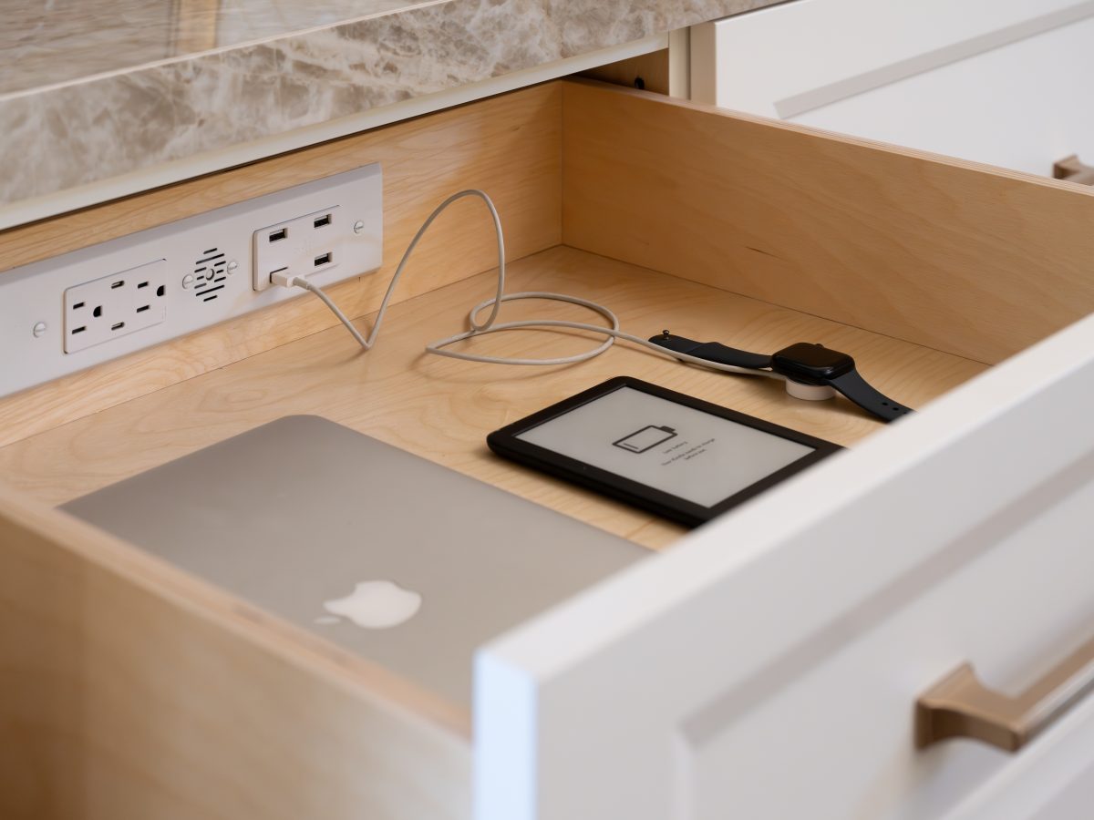 Kitchen charging drawer with built-in power outlets, Apple MacBook, Kindle, and Apple Watch, Reveal Interior Design Las Vegas