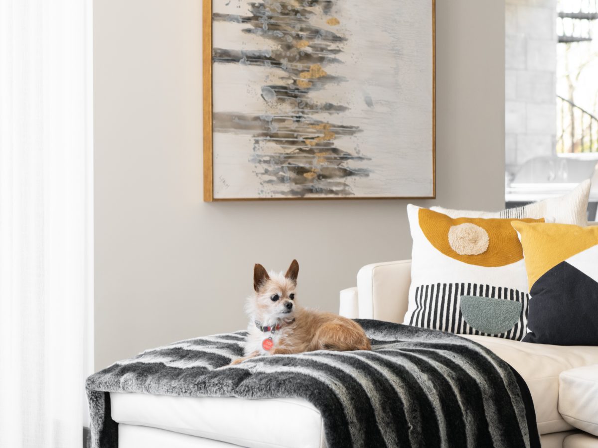 Luxury custom sectional with chaise, faux fur throw, and abstract art, Reveal Interior Design Las Vegas