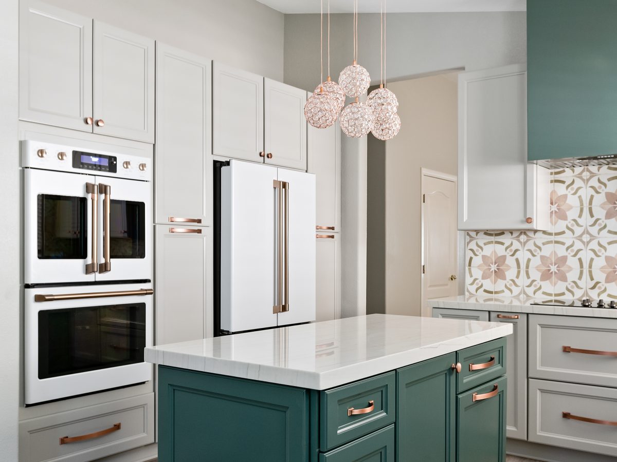 Transitional kitchen with emerald green island, white quartz countertops, and copper hardware, Reveal Interior Design Las Vegas