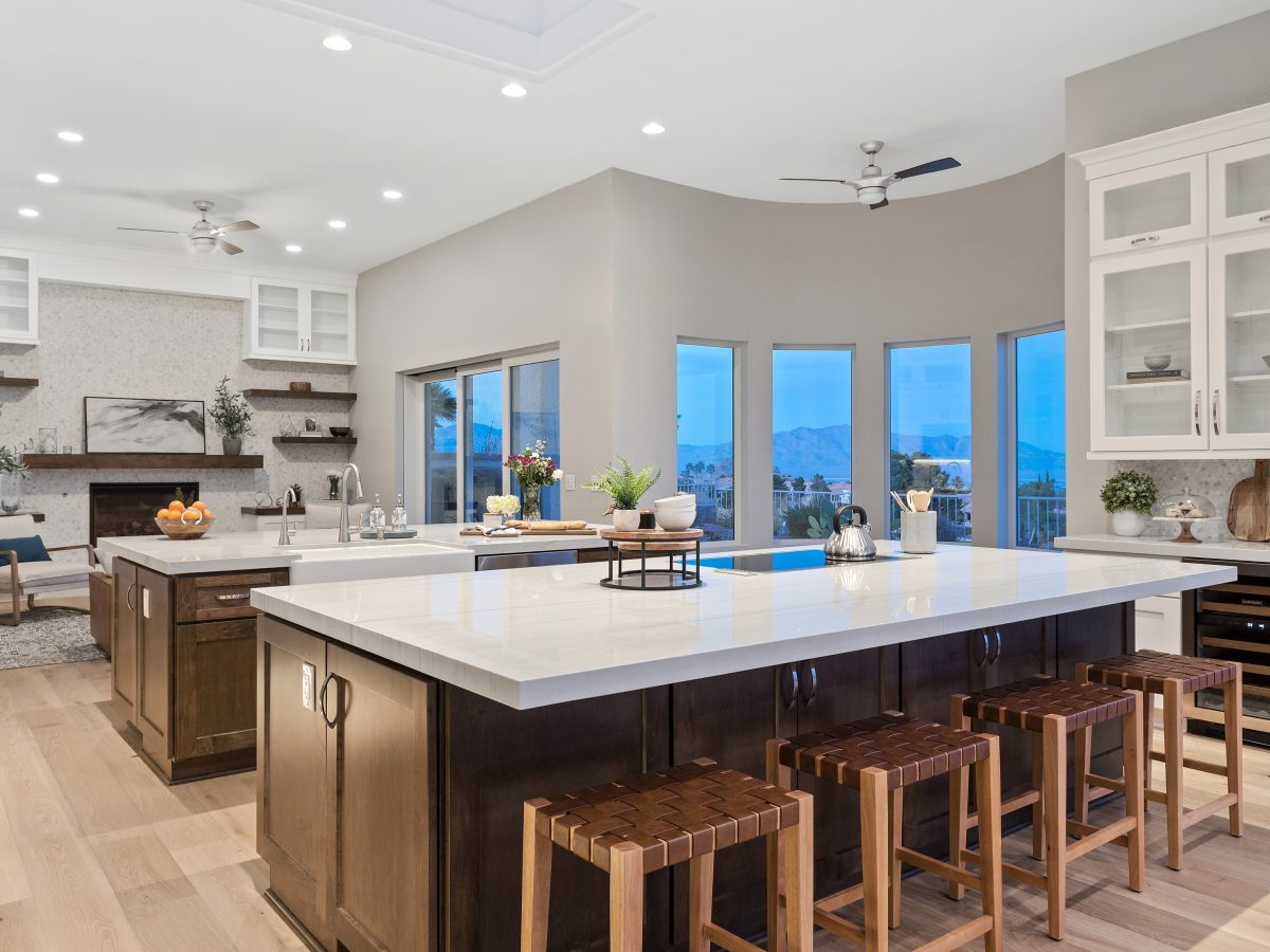 Transitional kitchen with Taj Mahal quartzite islands and dark stained maple cabinetry, Reveal Interior Design Las Vegas