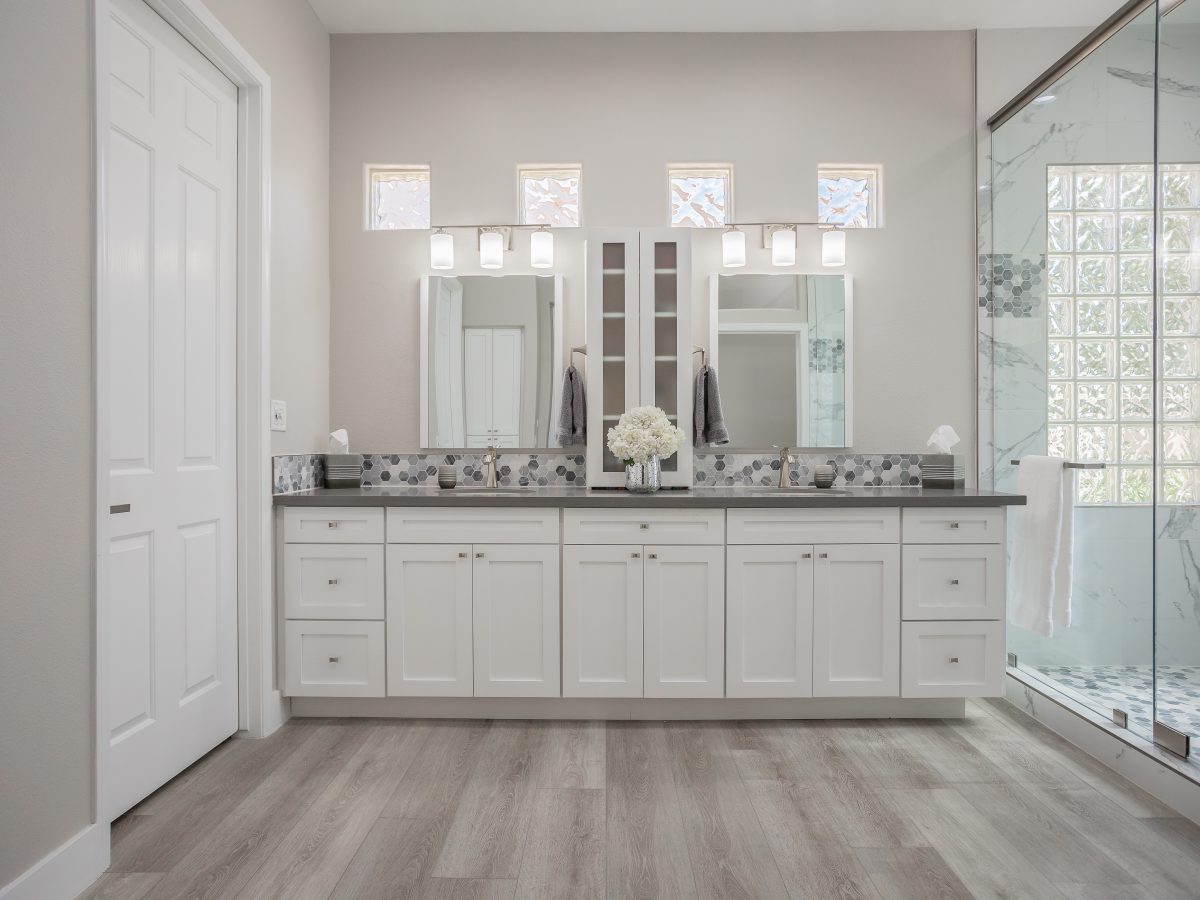 Primary bathroom with white shaker vanity, greige quartz countertops, and marble-look porcelain shower, Reveal Interior Design Las Vegas