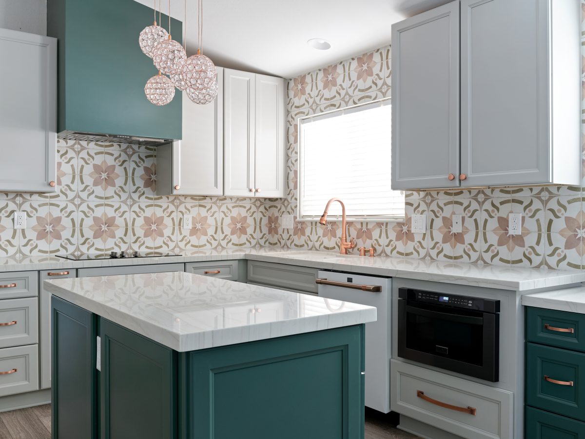 Emerald green and beige kitchen with encaustic ceramic tile backsplash, white quartz countertops, and copper hardware, Reveal Interior Design Las Vegas