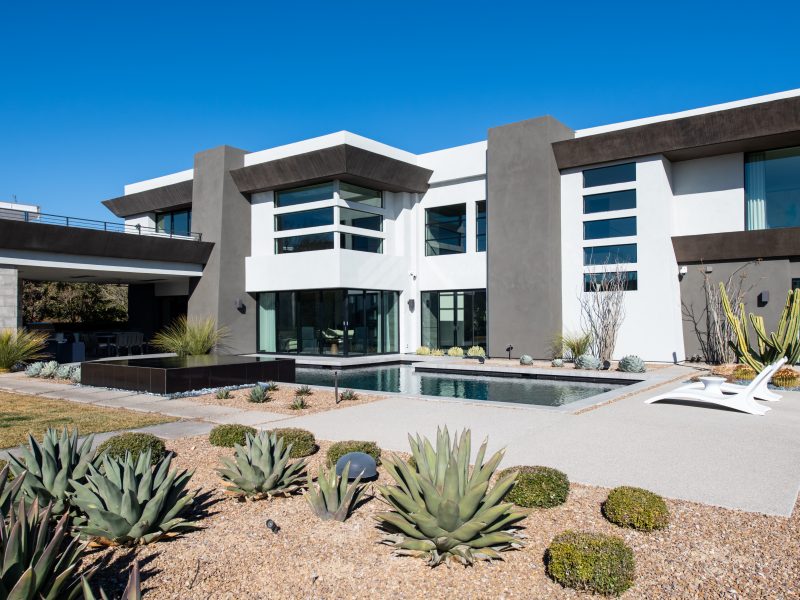 Desert Modern luxury estate exterior with geometric pool and xeriscape landscaping, Reveal Interior Design Las Vegas
