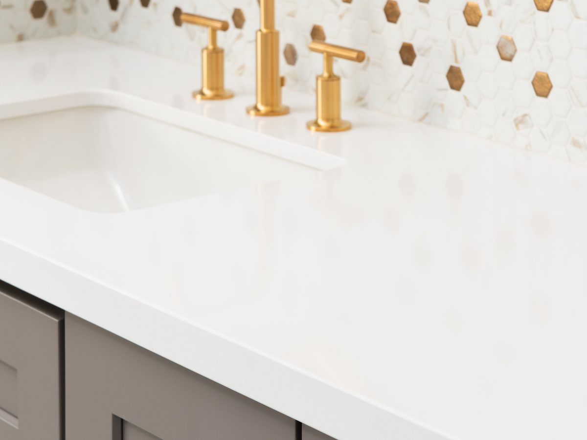 Primary bathroom vanity with calacatta-look mosaic tile backsplash and brushed gold fixtures, Reveal Interior Design Las Vegas