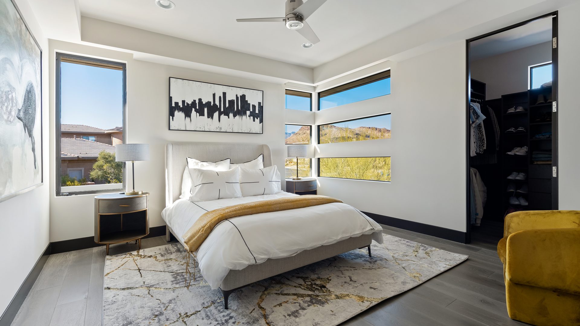 Desert Modern secondary bedroom with gold accents, corner windows, and walk-in closet, Reveal Interior Design Las Vegas