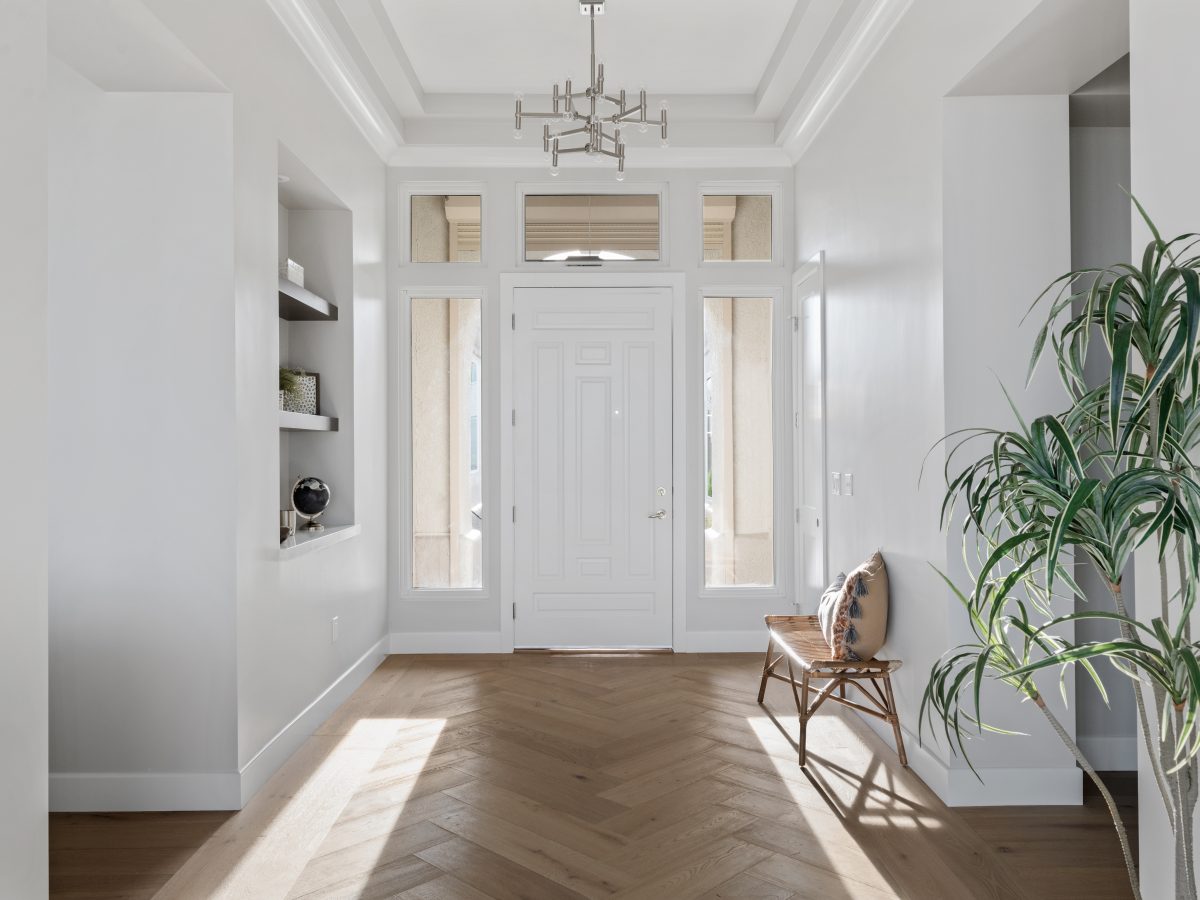 Elegant entryway with herringbone engineered hardwood and floating niche shelves, Reveal Interior Design Las Vegas