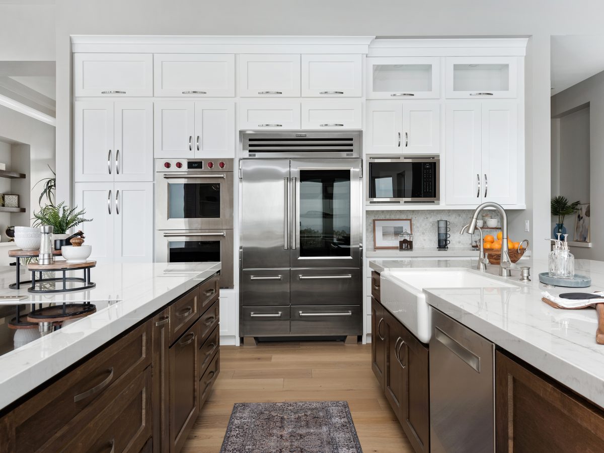 Transitional kitchen with Taj Mahal quartzite countertops and dark stained maple cabinetry, Reveal Interior Design Las Vegas