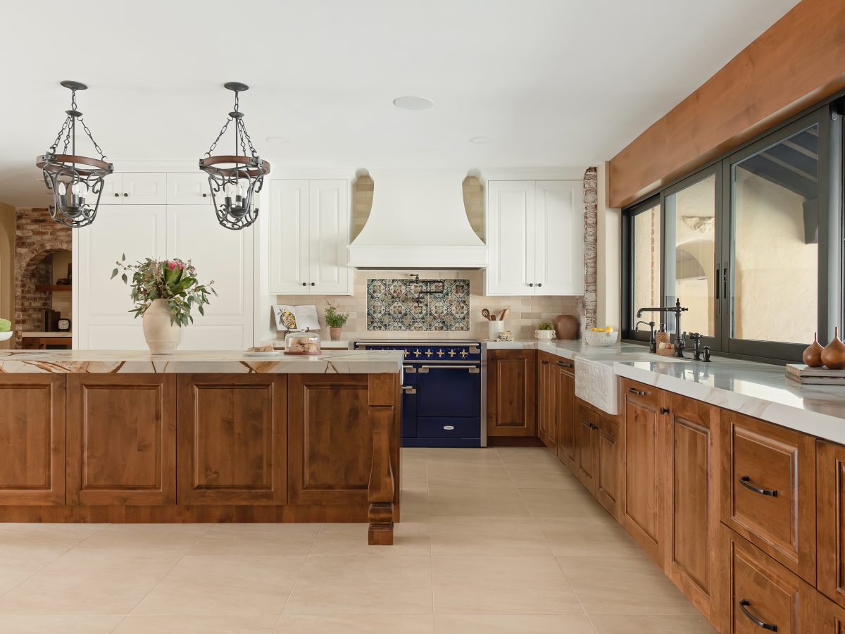 Spanish Modern kitchen with blue quartzite island, stained maple cabinetry, and blue dual-fuel range, Reveal Interior Design Las Vegas