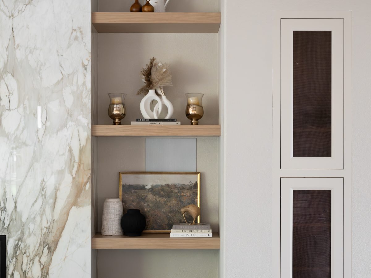 Living room built-in shelving with Taj Mahal Dekton stone fireplace surround, Reveal Interior Design Las Vegas