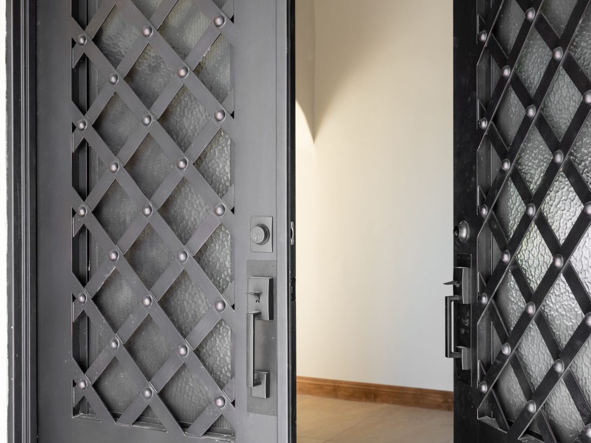 Entryway with 9-ft semi-custom arched iron double doors in Spanish Modern style, Reveal Interior Design Las Vegas