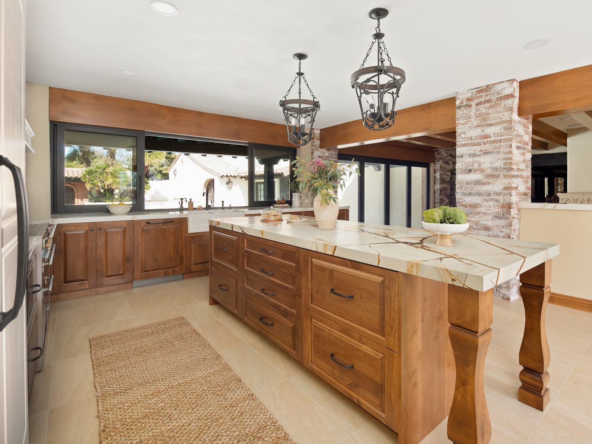 Spanish Modern kitchen with blue and gold quartzite island, stained maple cabinetry, and whitewashed brick, Reveal Interior Design Las Vegas