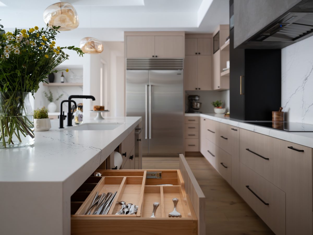 Contemporary kitchen with white-washed oak cabinetry, black-veined white quartz countertops, and matte black accents, Reveal Interior Design Las Vegas