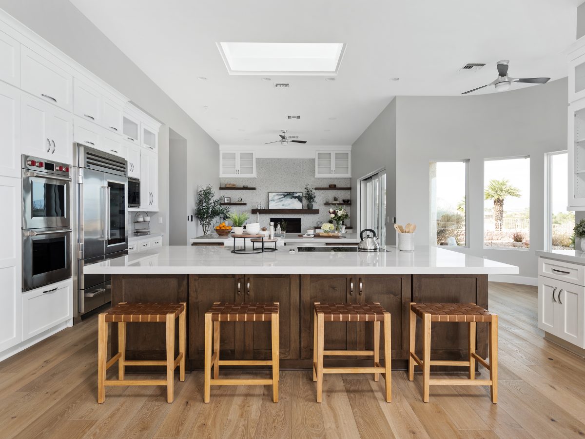Transitional kitchen with Taj Mahal quartzite island, dark stained maple and off-white shaker cabinetry, Reveal Interior Design Las Vegas